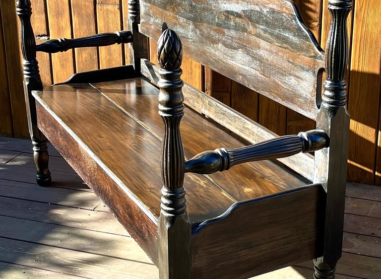 Wood bench created from a weathered antique bed frame.