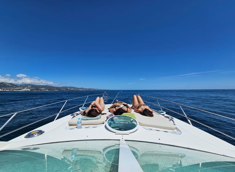 two people laying on a boat in the ocean