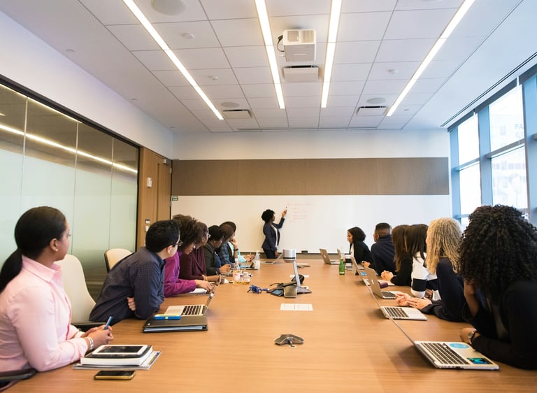Attendees listen to a speaker during a leadership development presentation.