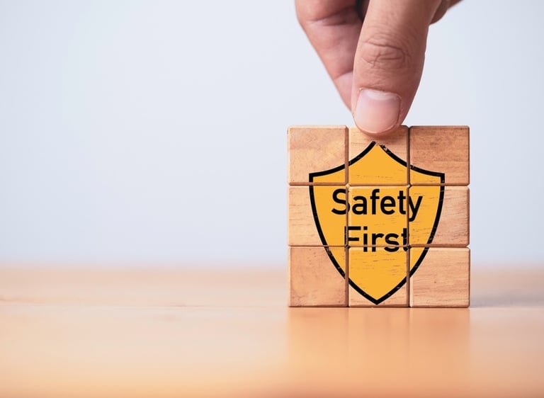 Building blocks with the graphic of a yellow shield saying "Safety First" on the front