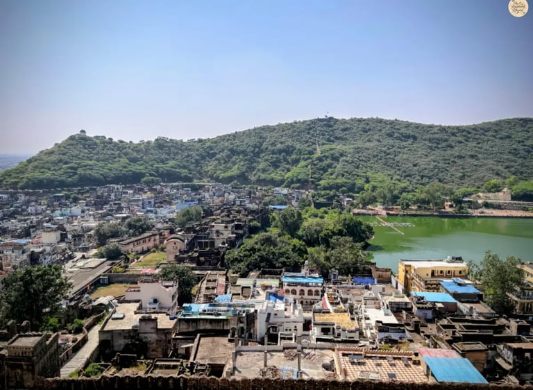 Panoramic view of Bundi town and Nawal Sagar Lake from Garh Palace, capturing the blue houses, serene waters, and royal charm