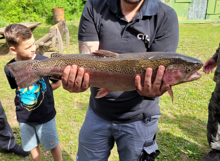 a man holding a fish on a field