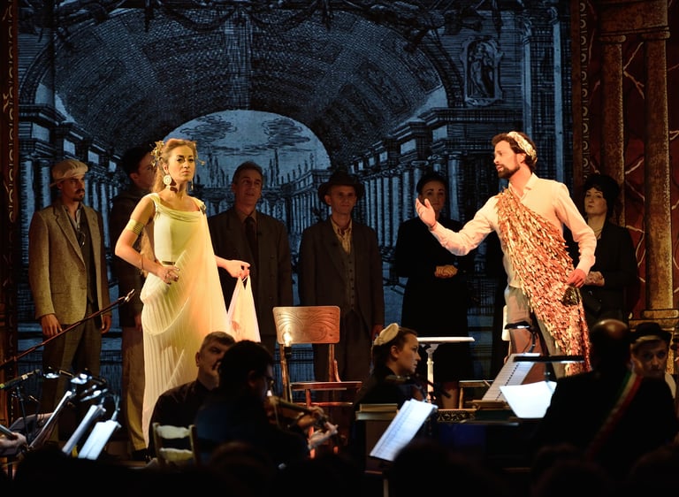 Actors in classical and modern costumes performing on stage during a theatrical opera production.