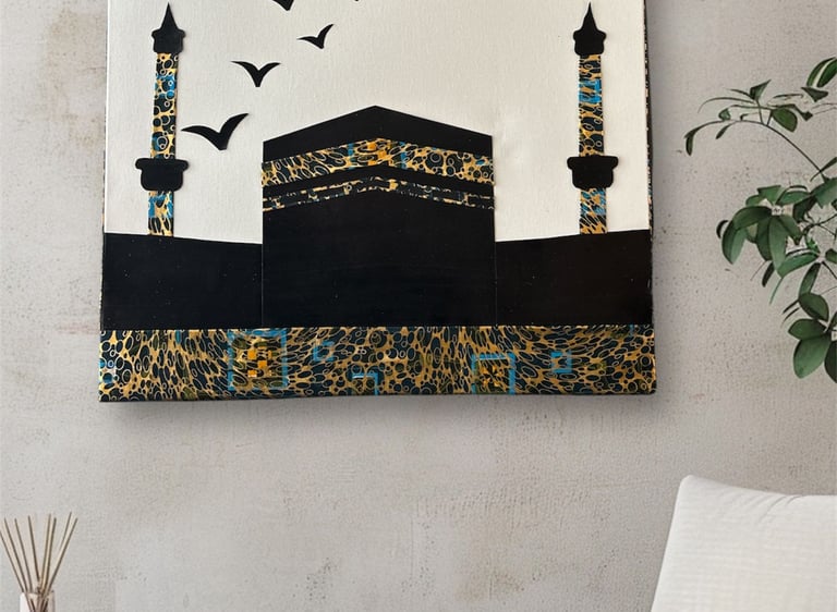 Modern Kaaba wall art with gold and blue patterns on a textured wall in a minimalist room.