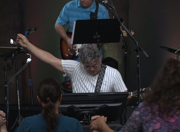 a man playing a keyboard and a woman singing
