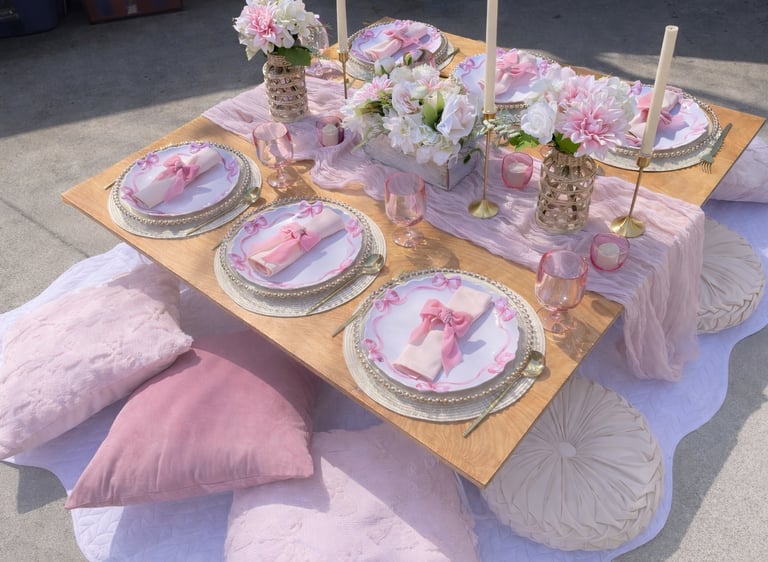 Gathered Grace Picnic Co pink bow themed luxury picnic for parties, 6 place settings at low table