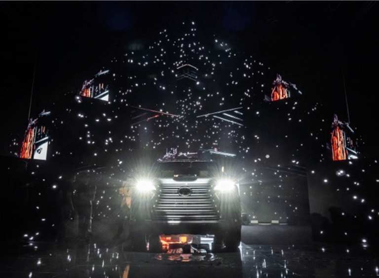 A car launch event featuring dynamic lighting, digital visuals, and an intricate stage design with a