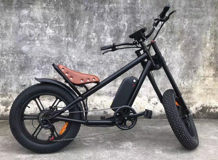 a black and white motorcycle with a brown seat