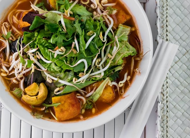a bowl of soup with vegetables and noodles