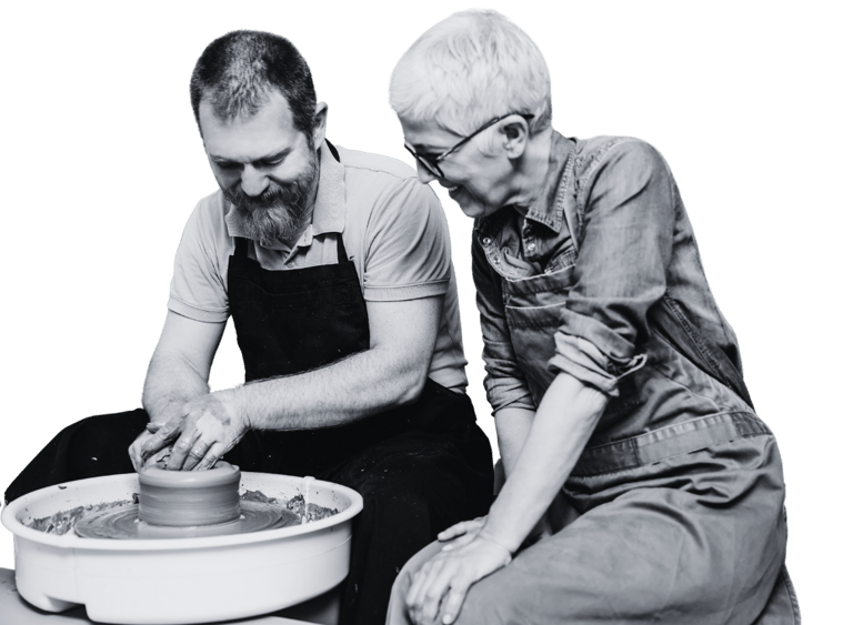 A man and woman using a pottery wheel