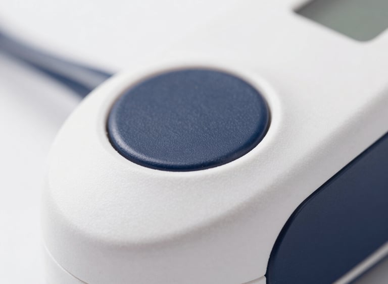 Macro shot of a premium medical device with diffused studio lighting, shallow depth of field, white and deep navy tones