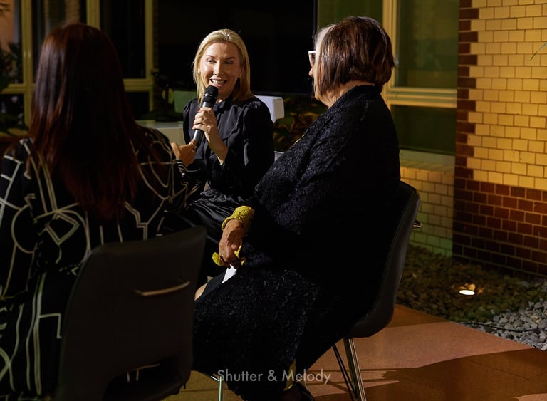 Host addressing two speakers at an event at the Australian Embassy in Berlin.