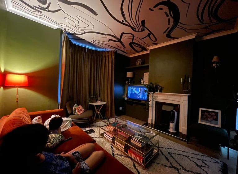 Wallpapered ceiling in  patterned monochrome paper and reflected in rug 
