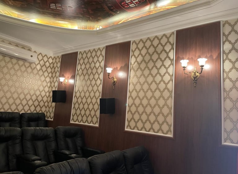 a cinema room with chandeliers and some cinema chairs