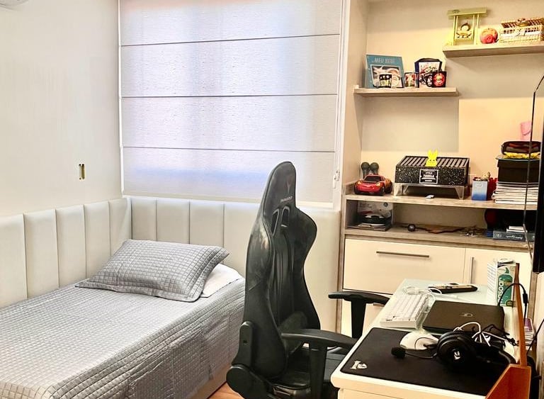 a bedroom with a bed and desk area