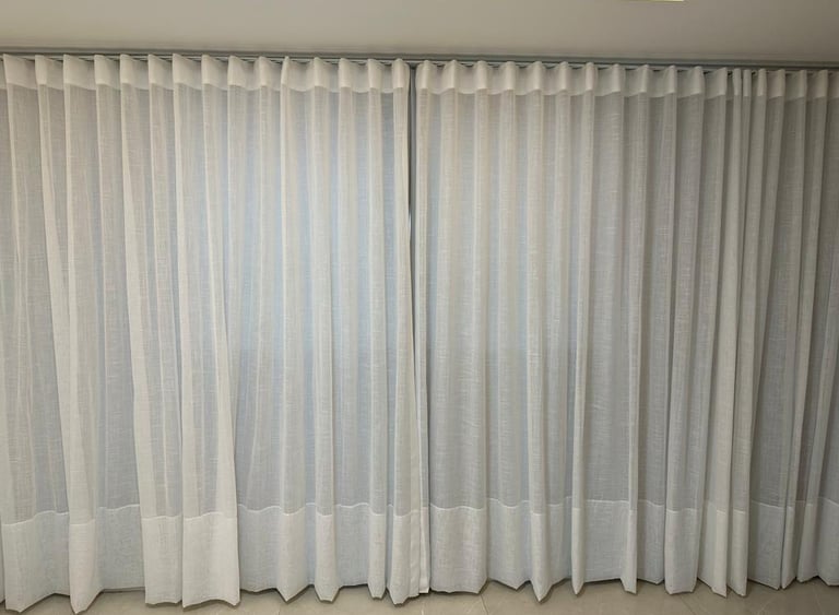 a curtained window with curtains and curtains