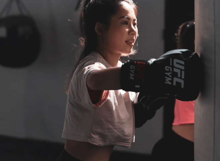 girl playing box at gym