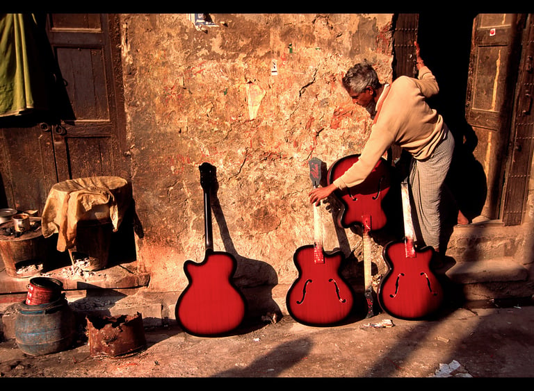 Freshly painted guitars dry outside the craftman's workshop in Kolkata, India.