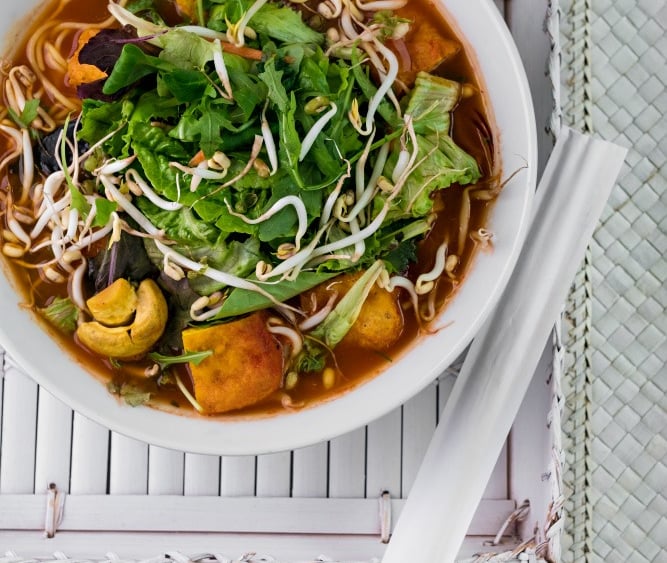 a bowl of soup with vegetables and noodles