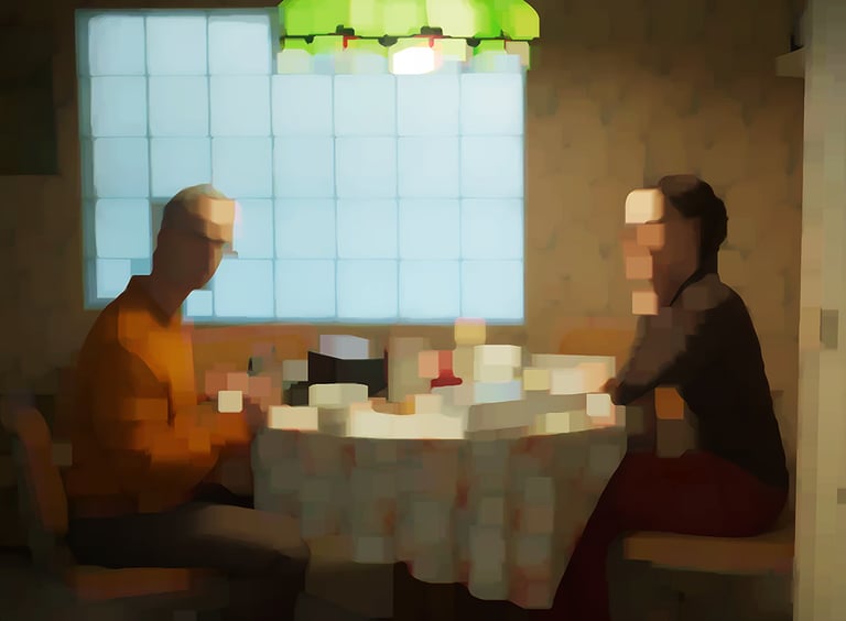 two people sitting at a table with a table cloth