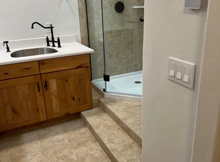 Full bathroom renovation in Fraser, CO featuring walk-in tile shower and custom vanity.
