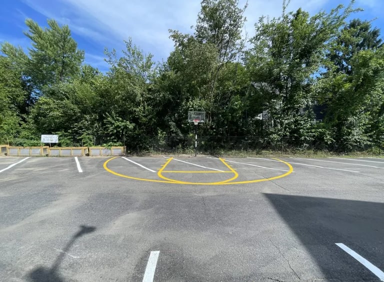 Freshly painted basketball court in parking lot