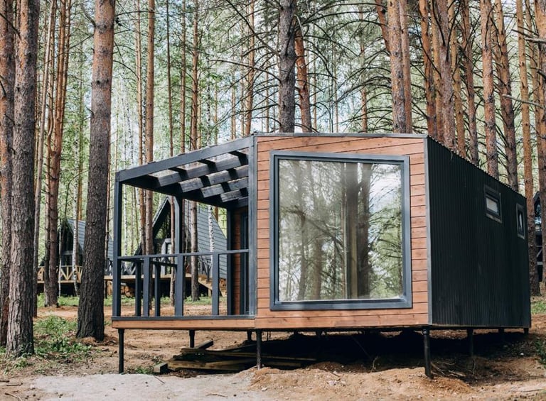 a tiny cabin in the woods with a bicycle