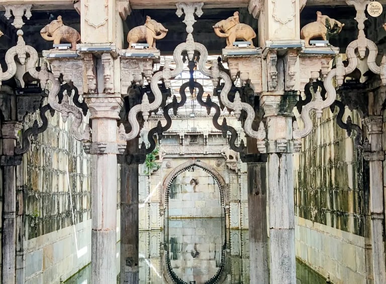 Ornate arches reflecting in the still waters of Rani Ji Ki Baori, Bundi — a mesmerizing play of stone and silence.