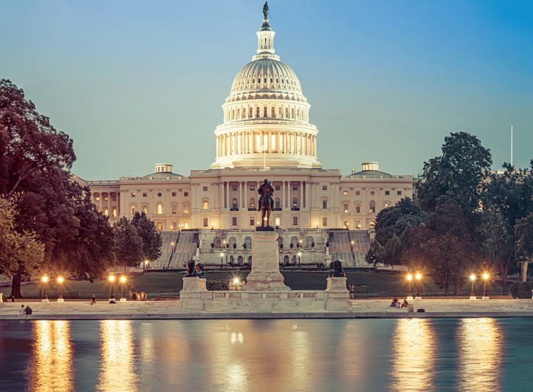 a large white building with a clock tower in the background