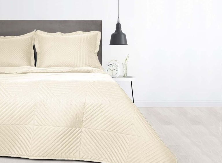 a bed with a white bed and a lamp