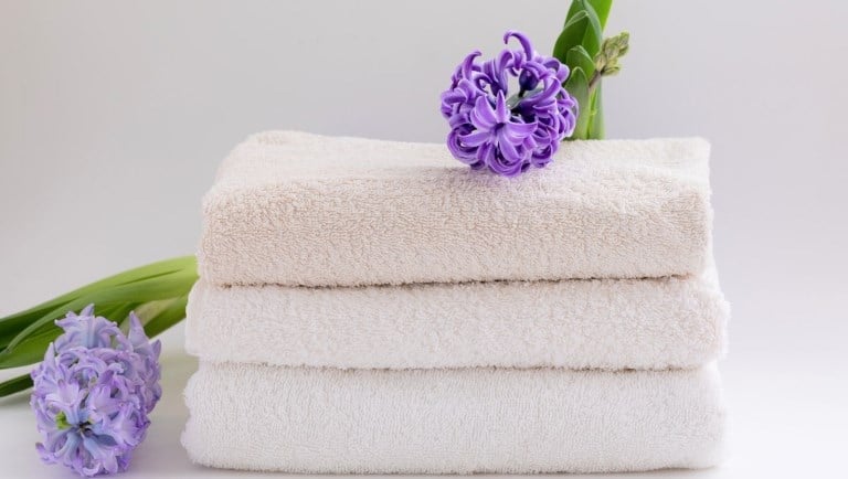 a stack of towels with flowers on a white background