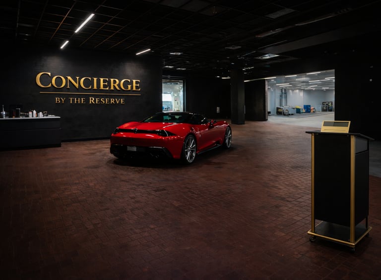 Red Ferrari parked inside the luxury Concierge by the Reserve high-end vehicle storage facility.