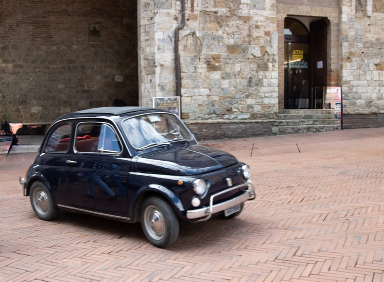 a small car parked in front of a building