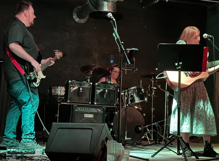 onstage image of band playing with john and rachel