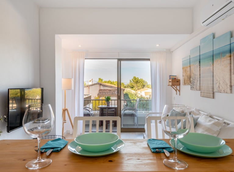 a dining table with a table setting for two