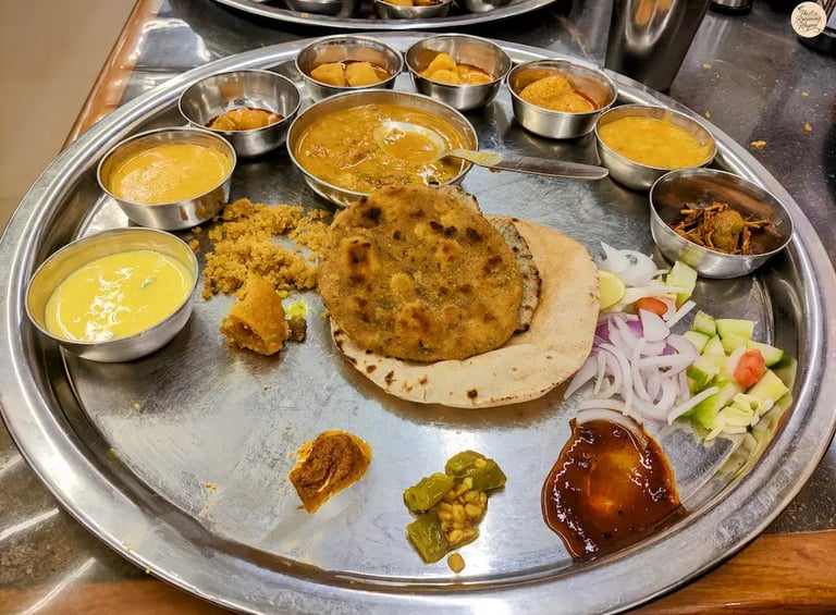 Rajasthani thali at Gypsy Restaurant Jodhpur with dal baati churma and traditional curries.