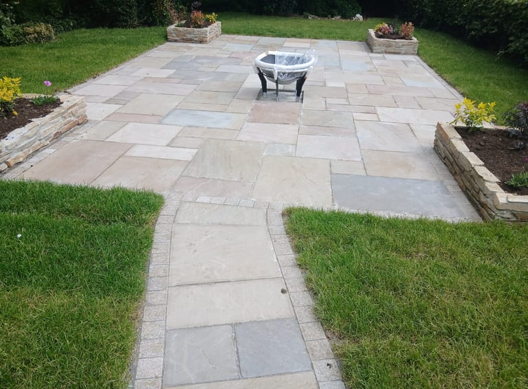 a patio with a fire pit and a fire pit