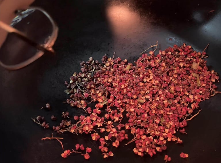 cooking in a wok pan with Sichuan Pepper