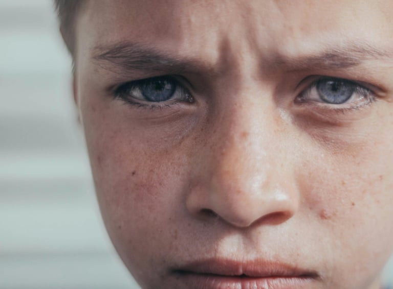 a young boy with a tie on his neck