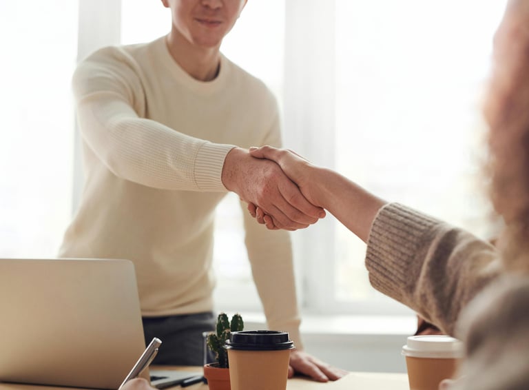 a man and woman shaking hands in a meeting