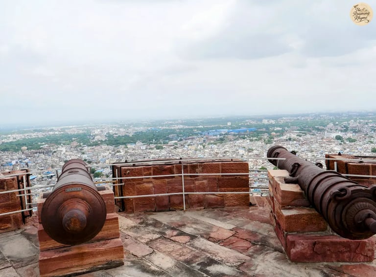 Aligned cannons on the ramparts of Mehrangarh Fort Jodhpur overlooking the panoramic Blue City view.