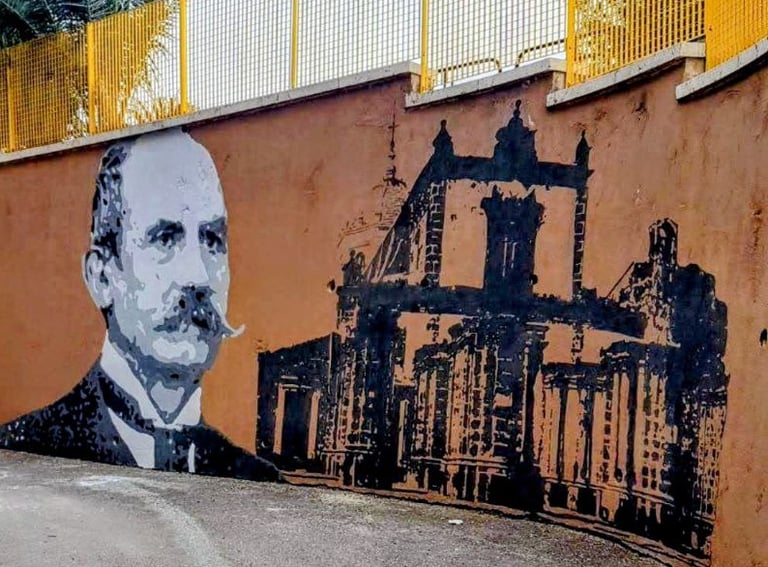 Mural dedicated to Italian historical figures, urban art created by Poliops with warm tones and arch