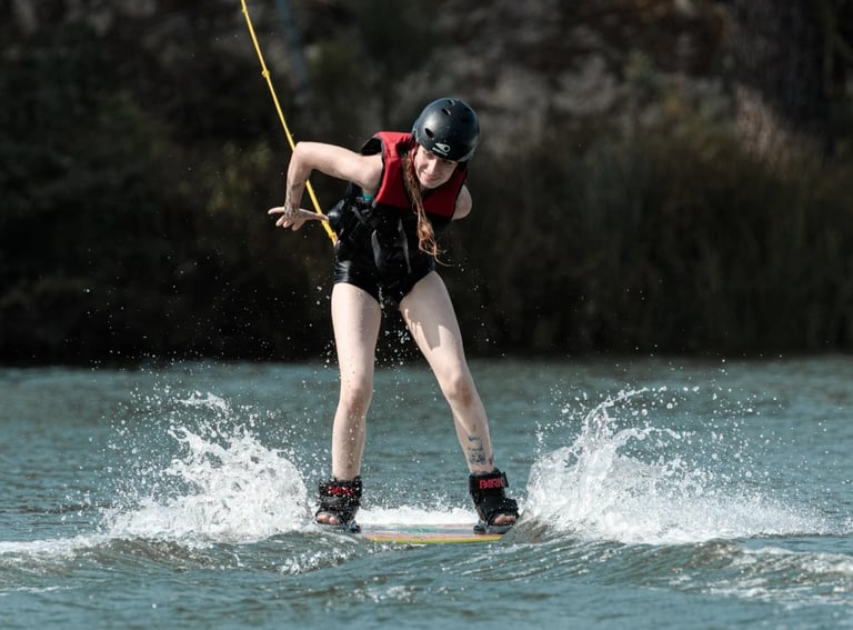Une femme en train d'effectuer une figure en wakeboard