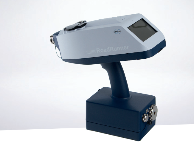 Bruker RoadRunner handheld explosives and narcotics trace detector with digital display on white background.