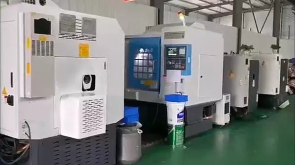 A row of industrial CNC milling machines in a modern factory production facility | RuiPros