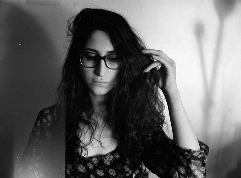 a woman with glasses and a flowered dress