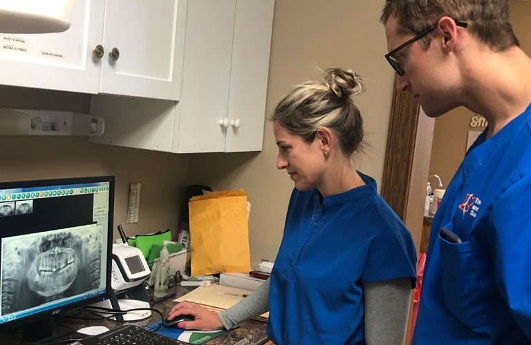 Our dental team reviewing x-rays of a patient's teeth