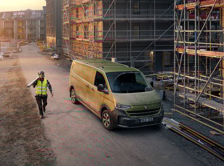 Construction worker beside a green VW Transporter in a national advertising campaign