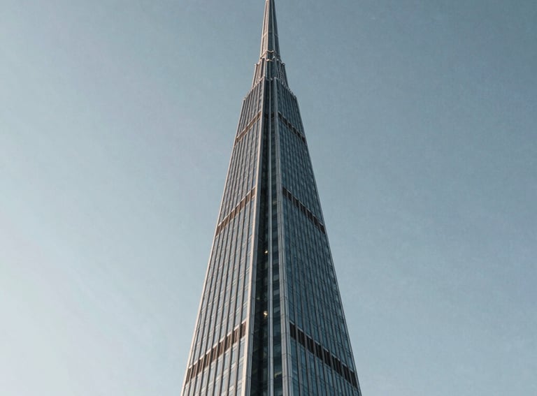 A low-angle shot of a modern glass spire reaching toward a clear sky, symbolizing growth and leadership. The style is professional and minimalist. North American / International architecture.