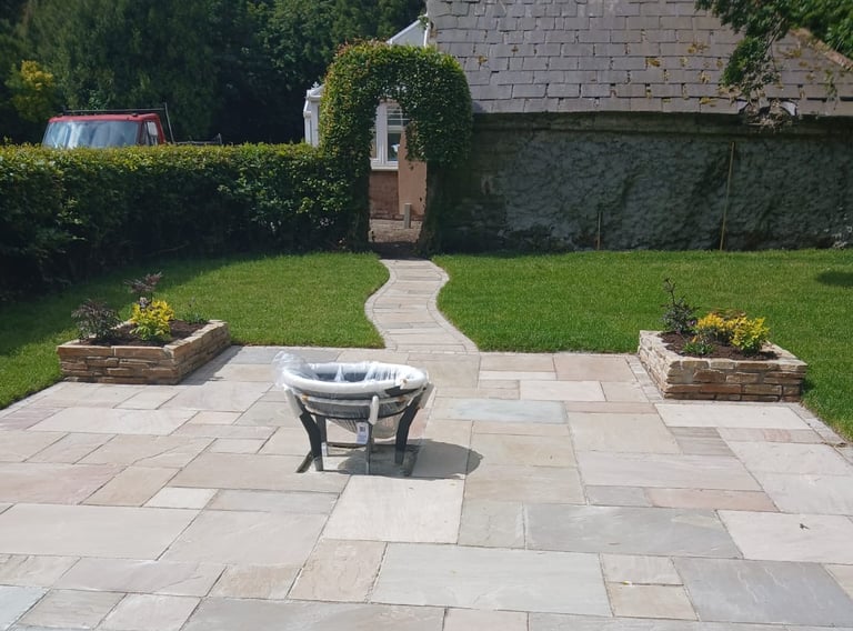 a patio with a table and chairs in the yard